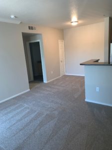 Elk Grove Affordable Apartments for Rent - Open-Concept Living and Dining Room with Plush Carpet and Natural Light.