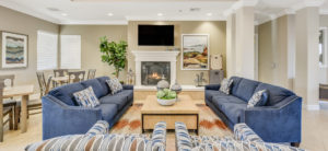 Elk Grove, CA Apartments - Community Clubhouse with Multiple Tables, Seating, a TV, and Sofas